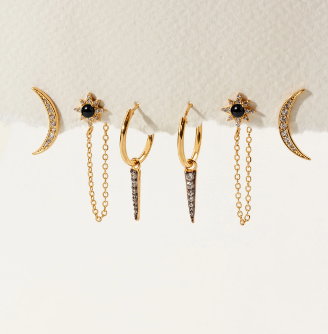 Set of gold earrings with black stone and crystal details.