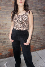 A timeless piece for any wardrobe, with a tan background, and realistic animal print, wide straps, and comfortable fabric.