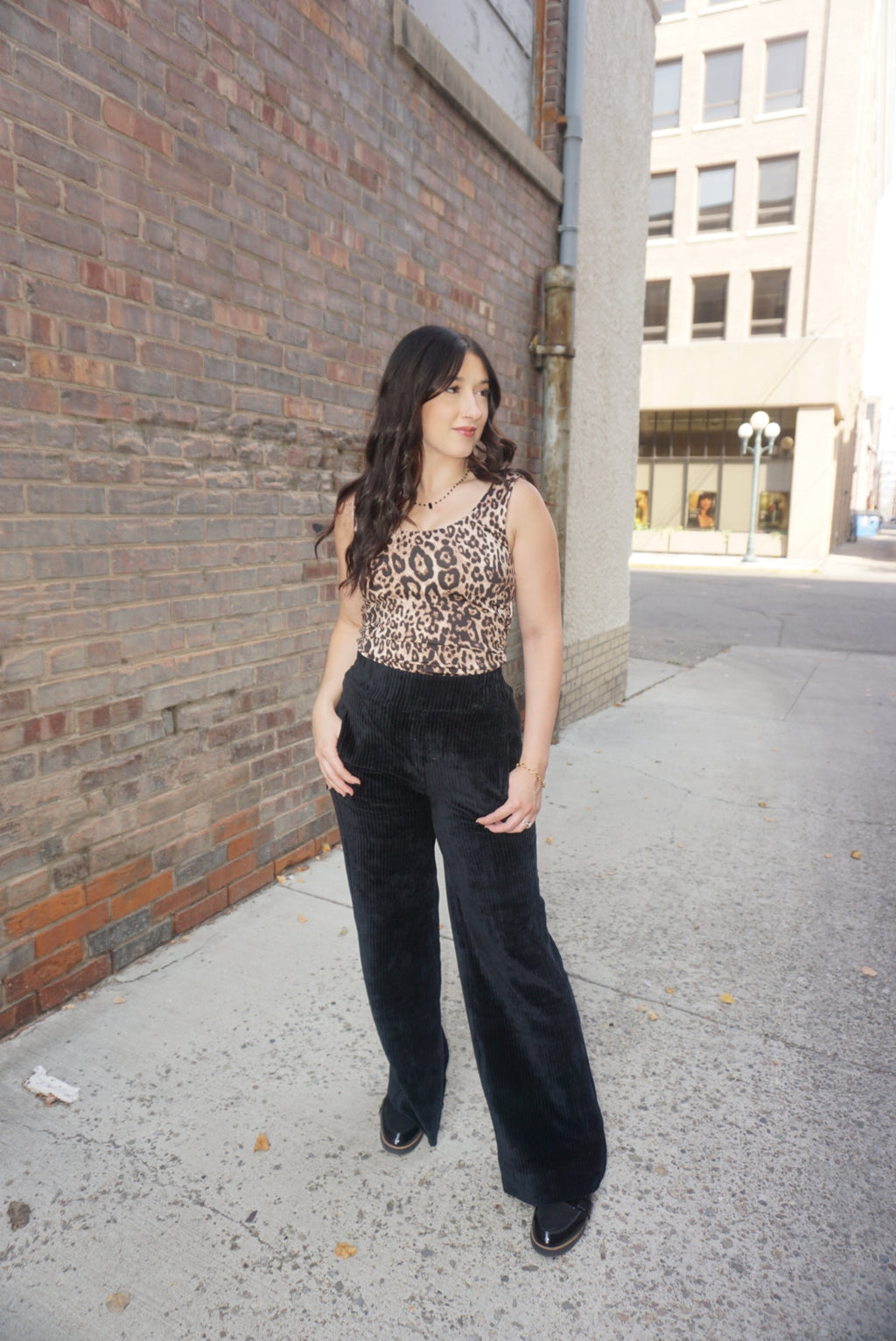 A timeless piece for any wardrobe, with a tan background, and realistic animal print, wide straps, and comfortable fabric.