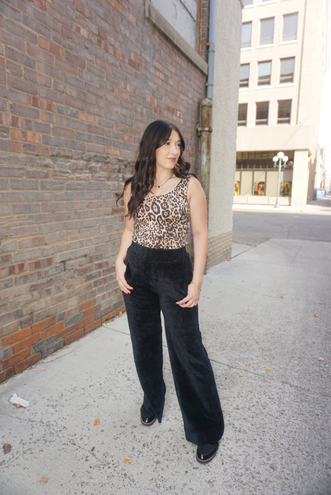 A timeless piece for any wardrobe, with a tan background, and realistic animal print, wide straps, and comfortable fabric.