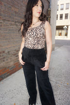 A timeless piece for any wardrobe, with a tan background, and realistic animal print, wide straps, and comfortable fabric.