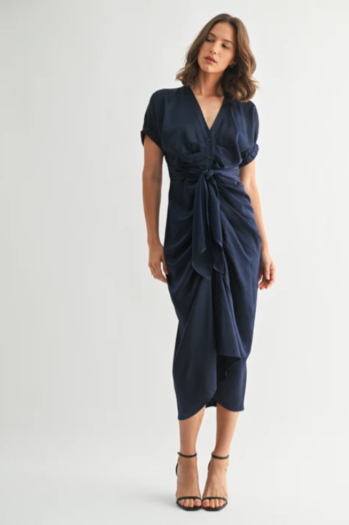 Woman wearing a navy blue dress on a white background