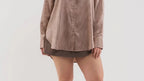Plus size model wearing a button down collared shirt