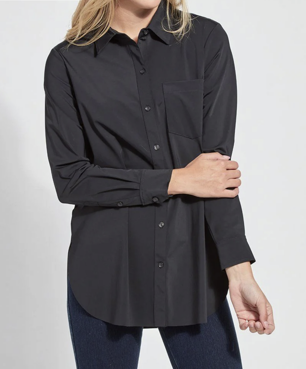 Person wearing a black button-up shirt and jeans on a white background