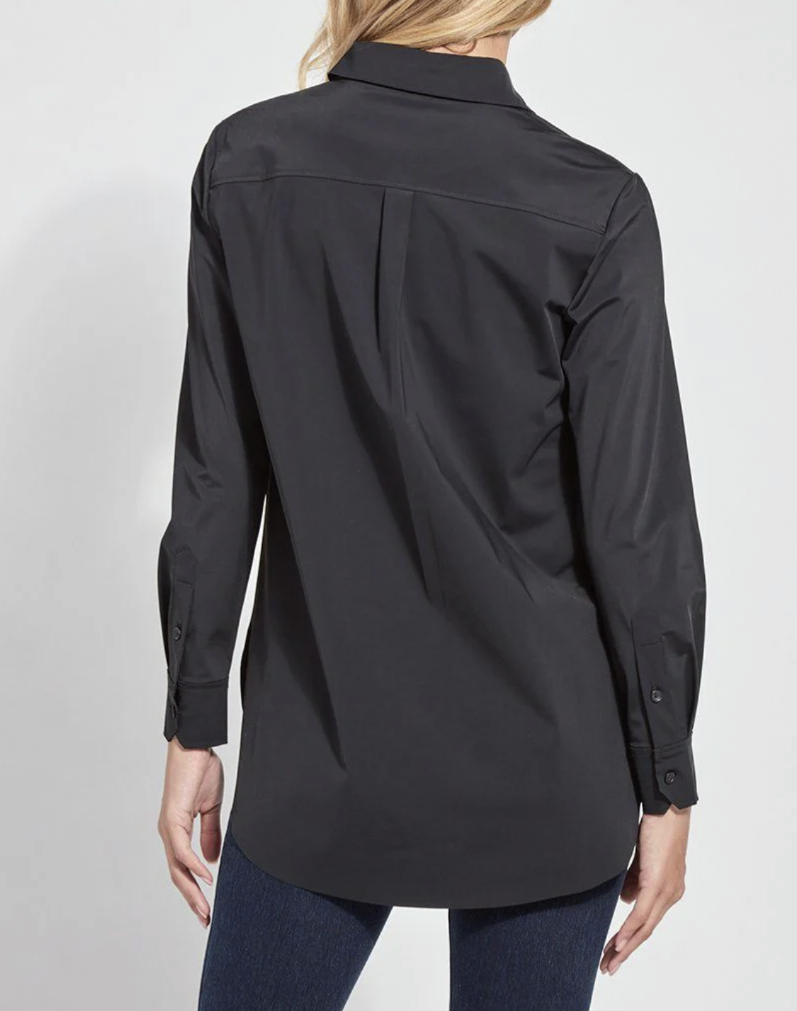 Black shirt worn by a person on a light gray background