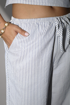 Striped pants with a drawstring waist, worn by a person.